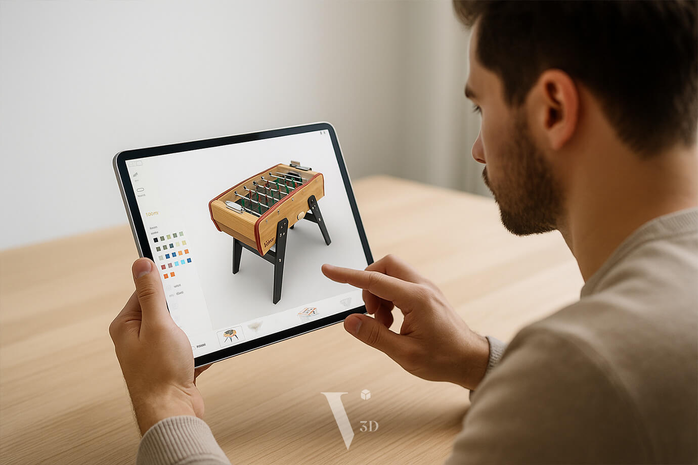 Person customizing foosball table using 3D configurator on laptop screen
